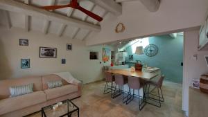 a living room with a couch and a table at La Bombonière & Spa in Roquebrune-Cap-Martin