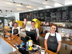 a group of people standing at a counter in a restaurant at The Lodges @ Barra Castle in Inverurie