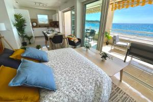 a bedroom with a bed and a view of the ocean at Magnificent 82m With Terrace And In Front Of Sea in La Seyne-sur-Mer