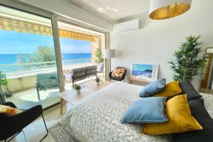 a bedroom with a bed and a view of the ocean at Magnificent 82m With Terrace And In Front Of Sea in La Seyne-sur-Mer