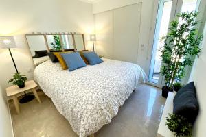 a bedroom with a large bed with blue pillows at Magnificent 82m With Terrace And In Front Of Sea in La Seyne-sur-Mer