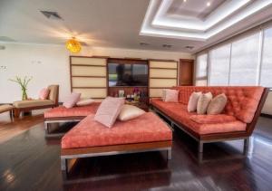 a living room with three couches in a room at Hillary Nature Resort & Spa All Inclusive in Arenillas