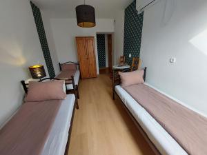 A bed or beds in a room at Palma Vendégház