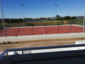 a tennis court seen through a window of a tennis court at CASA VISTA RIO ESPOSENDE in Esposende