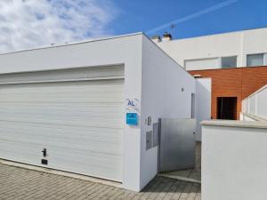 a white garage door with a blue sign on it at CASA VISTA RIO ESPOSENDE in Esposende