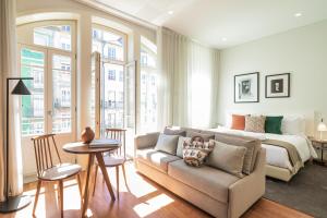a bedroom with a bed and a couch and a bed at Porto River Infante in Porto