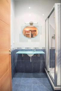 a bathroom with a sink and a mirror at Casa Naranja - Centrally located, spacious, unique in Donostia-San Sebastián