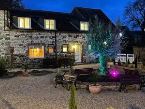 a stone house with a tree in the yard at May Cottage in Bridlington