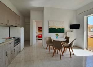een keuken en eetkamer met een tafel en stoelen bij Eva Ivoni apartments in Amoudara Herakliou