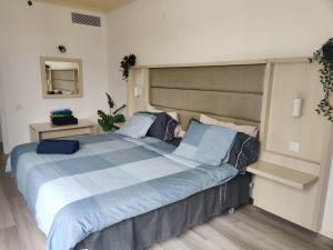 a bedroom with a large bed with blue pillows at Luxury Apartment with pool view in Adeje +33 photos