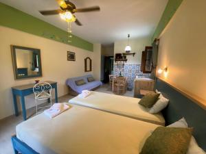 a bedroom with two beds and a living room at Harmony resort in Parga +100 photos