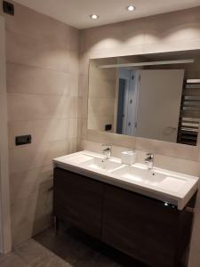 a bathroom with two sinks and a large mirror at MACH HOUSE you will like it ! in Tamariu