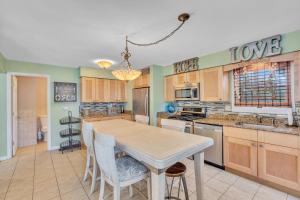 a kitchen with a table and chairs in it at Saltwater Inn in Belmar