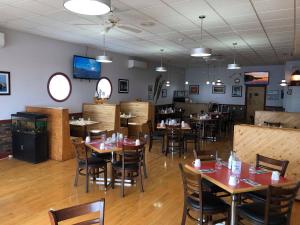 a dining room with tables and chairs in a restaurant at Sea Echo Motel in Port au Choix