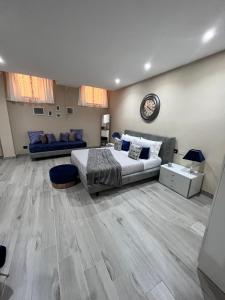a large bedroom with a bed and a couch at CB Rooms in Termini Imerese