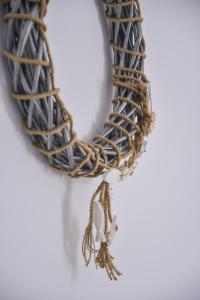 a necklace made out of rope and a pearl at Diamanto's guest house in Tripiti