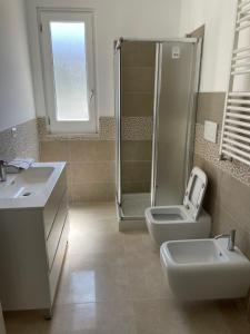 a bathroom with a shower and a toilet and a sink at Villa Portinente in Lipari +14 photos