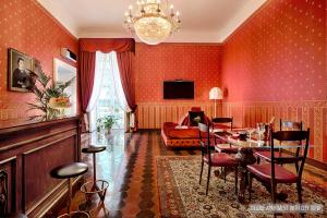 a living room with red walls and a table and chairs at La Casa Sul Nilo in Naples