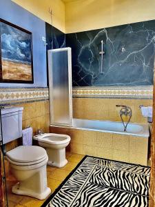 a bathroom with a toilet and a zebra print rug at Villa I Bossi in Arezzo