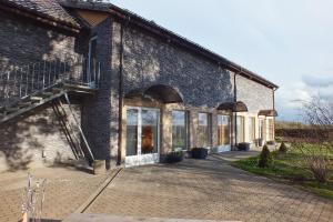 a large brick building with windows and a staircase at Toila Pikk Apartment in Toila