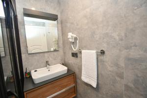 a bathroom with a sink and a mirror at Duygu Apart spellbinding sea views in Fethiye +59 photos