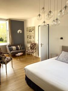 a bedroom with a bed and a living room at Hotel d'Angleterre Etretat in Étretat