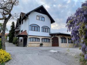 a white house with a black roof at Villa Repić in Slatina