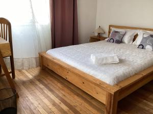 a bedroom with a bed with a wooden frame at Villa ChezSoa, Andoharanofotsy. in Antananarivo