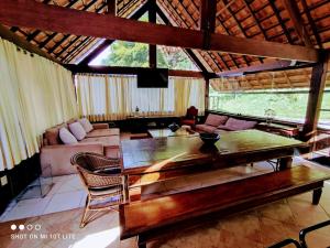 a living room with a table and a couch at Pousada Águas da Serra in Araras Petropolis