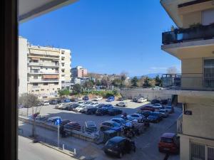 a view of a parking lot with cars parked at Emme Central - spacious apartment in Kavala