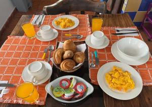 a table with plates and bowls of food on it at CASA VILLA LUGUIANGA Villa de Leyva in Villa de Leyva