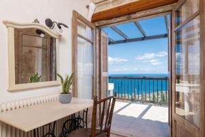 a dining room with a view of the ocean at Strofilia Authentic Villas in Skinária