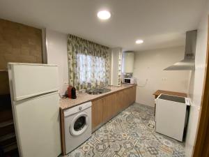 a kitchen with a refrigerator and a washing machine at Cala del Mar Apartment - La Cala de Mijas in La Cala de Mijas