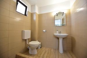 a bathroom with a toilet and a sink at Casa Ryn in Vama Veche +54 photos