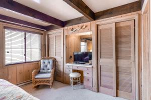 a bedroom with a bed and a desk and a television at White Sands Village 22 in Ocean City