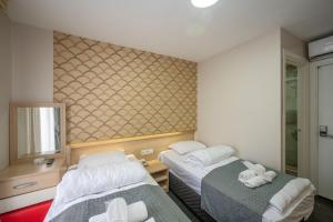 Postel nebo postele na pokoji v ubytování Hotel Melita