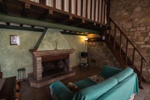 a living room with a couch and a fireplace at Bio Agriturismo Montemenardo Apartments in Todi