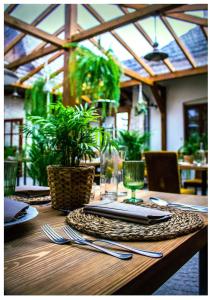 a wooden table with utensils on top of it at Folwark Walencja in Kazimierz Dolny