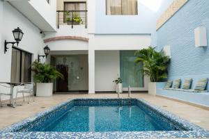 a swimming pool in the courtyard of a house at Hotel Virrey Cartagena in Cartagena de Indias
