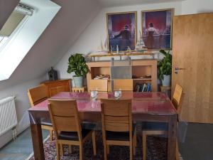 a dining room with a wooden table and chairs at Schöne gemütliche Ferienwohnung in Eggebek