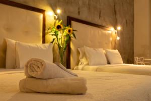 a hotel room with a towel on a bed at Hotel Virrey Cartagena in Cartagena de Indias