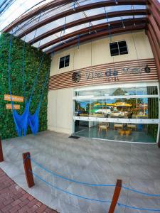 a view of a building with a table and chairs at Vila de Maré Hotel in Porto De Galinhas