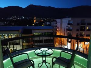 a balcony with a table and chairs on a building at Apartman Jelena Anžujska in Trebinje +5 photos