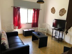 a living room with a couch and a tv at Casa en el Real de san carlos in Colonia del Sacramento