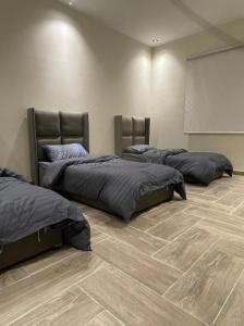 a room with two beds and a white screen at شاليهات ارينا الفندقية بالطائف in Ash Shuwaybiţ +12 photos