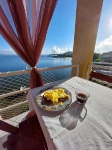a plate of food on a table on a balcony at Pousada Pedra das Tartarugas in São Francisco do Sul