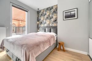 Posteľ alebo postele v izbe v ubytovaní Apartament 1000 Stare Miasto bulwary Apartamenty No 1