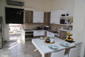 a kitchen with a table and chairs in it at CozyLuxuryApartment in Keramotí