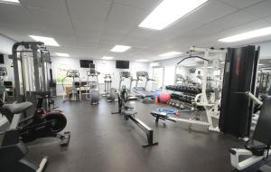 a gym with several treadmills and machines in it at Sugar Bay Barbados - All Inclusive in Bridgetown