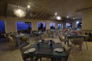 a restaurant with tables and chairs with a view of the ocean at Sugar Bay Barbados - All Inclusive in Bridgetown